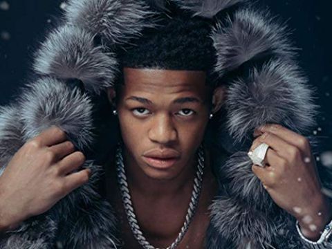 YK Osiris poses for a picture in a fur jacket.